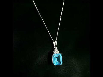 Swiss blue topaz pendant with emerald-cut blue topaz and diamond accents in 18K white gold.