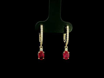Ruby and diamond drop earrings in 18K yellow gold with oval ruby drops and diamond set hoops