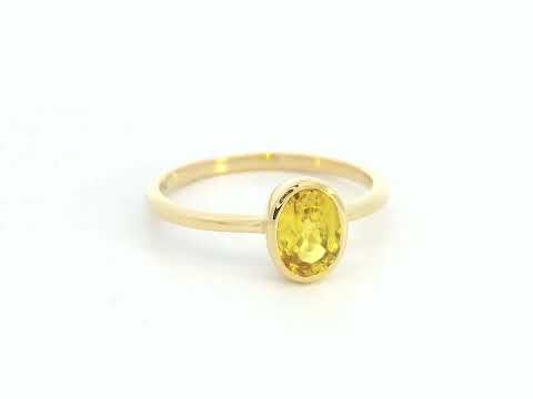 Yellow sapphire solitaire ring in 18K yellow gold featuring a 1.16 carat oval cut gemstone by Emirates Diamonds