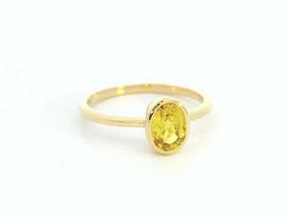 Yellow sapphire solitaire ring in 18K yellow gold featuring a 1.16 carat oval cut gemstone by Emirates Diamonds