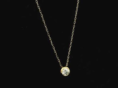 18K yellow gold diamond solitaire necklace featuring a 0.43 carat natural diamond in a modern bezel setting.