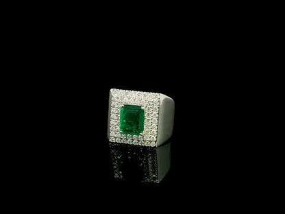 Men’s emerald and diamond statement ring in 18K white gold with rectangular green emerald and diamond surround.