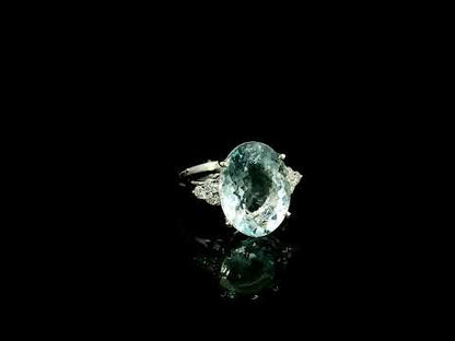 Oval aquamarine and diamond statement ring in 18K white gold with diamond side accents