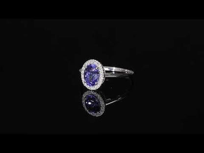 Tanzanite and diamond ring in 18K white gold with oval tanzanite and round diamond halo