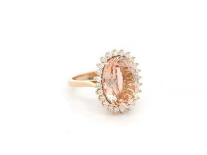 18K rose gold morganite and diamond halo ring featuring an oval morganite and sparkling diamond accents by Emirates Diamonds.