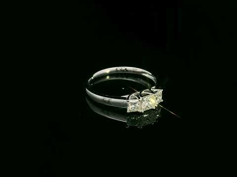 18k white gold trilogy ring with three princess-cut diamonds, total 0.66 ct, modern classic design.