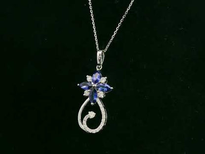 18K white gold Tanzanite and diamond floral paisley pendant featuring marquise-cut Tanzanites and pavé-set diamonds