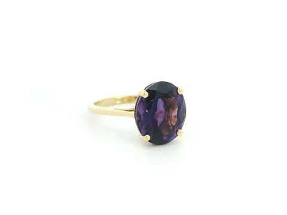 Oval amethyst solitaire ring in 18K yellow gold featuring a 4.39 carat natural amethyst by Emirates Diamonds.