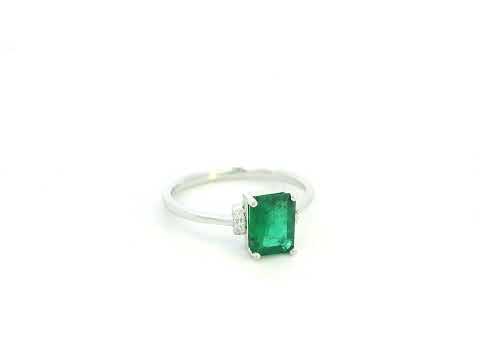 Emerald cut emerald ring with diamond accents in 18K white gold
