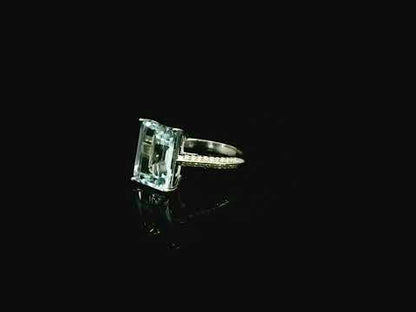 Emerald cut aquamarine ring in 18K white gold with pavé diamond band