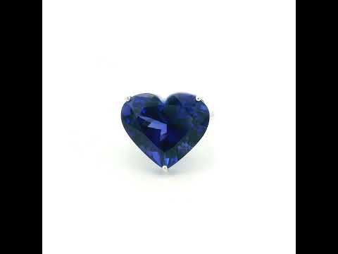 Heart shaped tanzanite ring in 18K white gold featuring a 25.18 carat blue-violet gemstone and diamond-set shoulders.