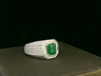 18K white gold men’s ring with emerald-cut emerald and diamond halo.
