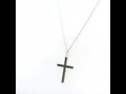 Black diamond cross pendant in 18K white gold set with round black diamonds in a slender cross design.