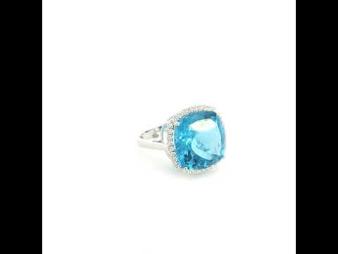 18K white gold cushion cut blue topaz halo ring featuring an 18.55 carat natural blue topaz surrounded by 0.37 carat natural diamonds.