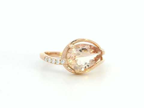 Close-up of pear-cut morganite and sparkling diamonds on rose gold band