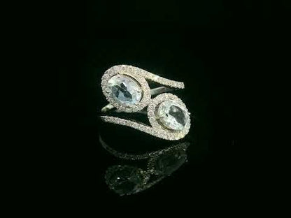 Video of 18k white gold ring with two oval aquamarines and 0.39 ct diamond halos
