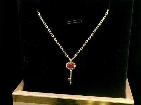 18K gold key pendant necklace with a 0.39ct natural ruby, featuring a sleek bezel setting and a delicate gold chain.