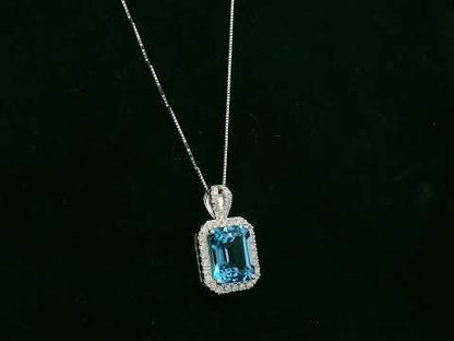 18K white gold Swiss blue topaz and diamond halo pendant necklace by Emirates Diamonds