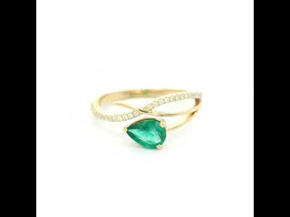 18K yellow gold emerald crossover ring featuring a 0.51 carat natural emerald and 0.09 carat natural diamond accent band.