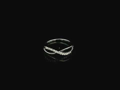 18K white gold diamond crossover ring featuring a crisscross design with 0.16 carat natural diamonds and polished white gold bands.