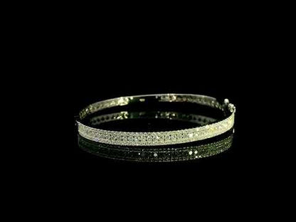 Three row diamond bangle in 18K white gold with parallel rows of round diamonds across the front.
