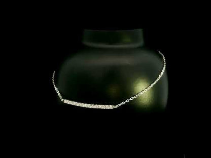 Diamond bar bracelet in 18K white gold featuring a curved row of round brilliant diamonds on a fine chain.