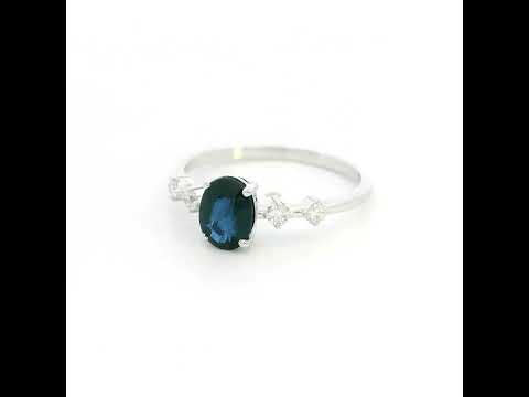Oval blue sapphire diamond ring in 18K white gold with round diamond side stones