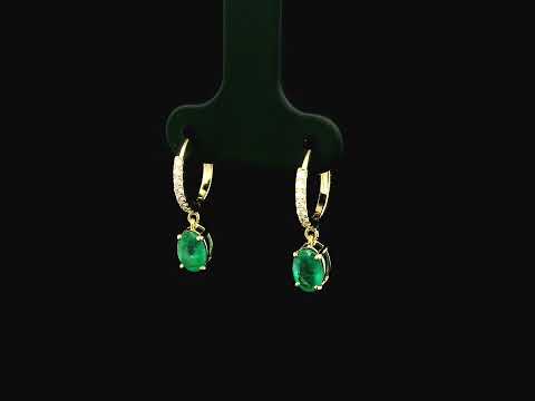 Emerald drop hoop earrings in 18K yellow gold with 0.95 carat emeralds and 0.09 carat diamond pavé hoops by Emirates Diamonds.