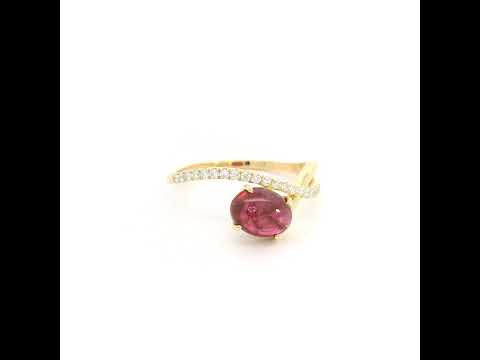 Oval cabochon ruby and diamond ring in 18K yellow gold with curved crossover band