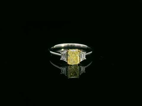 18K white gold fancy yellow radiant-cut diamond ring with tapered white diamond side stones – Emirates Diamonds.