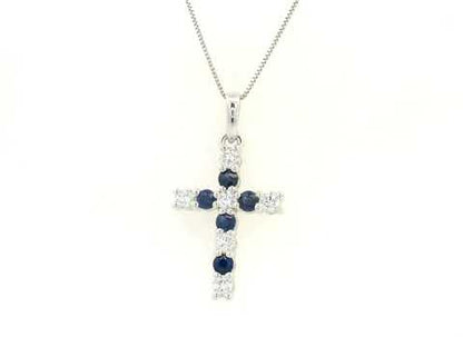 18K white gold diamond and blue sapphire cross pendant with prong-set gemstones by Emirates Diamonds.