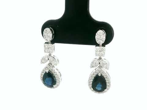 18k white gold dangle earrings with pear-cut blue sapphires totaling 1.85 carat and 0.55 carat diamonds in halo and filigree design