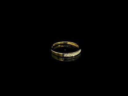 18K yellow gold princess cut diamond ring featuring 0.20 carat natural channel set diamonds in a polished minimalist band.