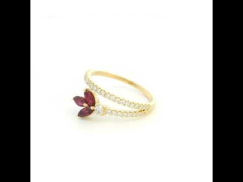 Ruby and diamond floral ring in 18K yellow gold with three marquise shaped rubies and sweeping diamond-set bands.