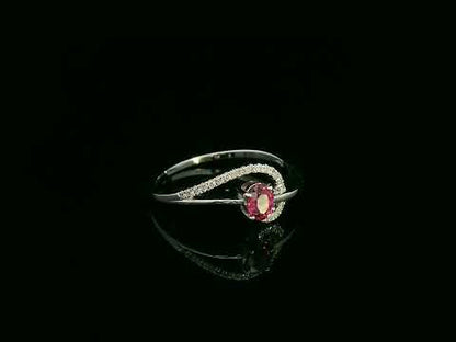 18K white gold ruby and diamond curved ring with oval ruby and flowing diamond-accented band by Emirates Diamonds