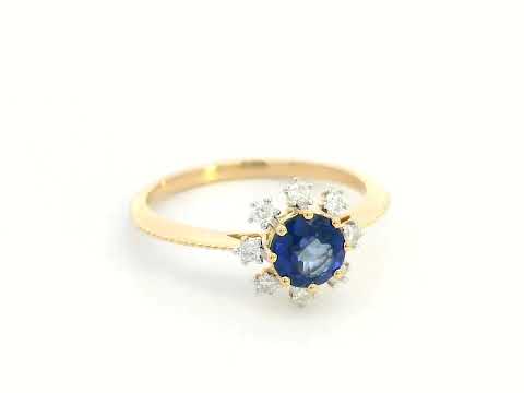 18K gold sapphire and diamond sunburst ring featuring a 0.79 CT royal blue sapphire with 0.15 CT diamonds in a floral-inspired setting.