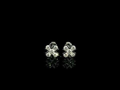 Four-petal diamond flower stud earrings in 18K white gold featuring round brilliant diamonds with minimal visible metal.