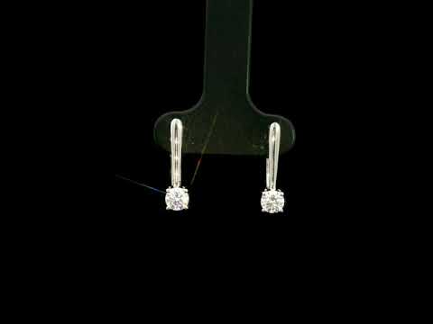 Round brilliant diamond drop earrings in 18K white gold featuring single four-prong set diamonds suspended beneath polished gold details.
