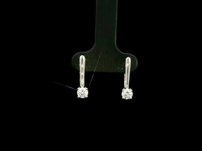 Round brilliant diamond drop earrings in 18K white gold featuring single four-prong set diamonds suspended beneath polished gold details.