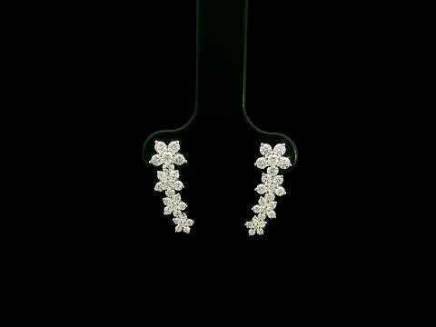 Diamond floral ear climber earrings in 18K white gold with graduating round diamond flower clusters designed to follow the ear.