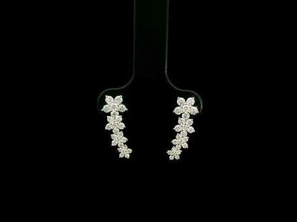 Diamond floral ear climber earrings in 18K white gold with graduating round diamond flower clusters designed to follow the ear.