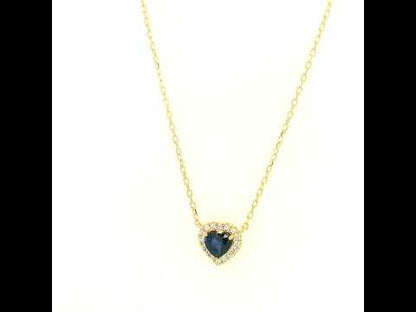 Heart-shaped blue sapphire and diamond halo pendant necklace in 18K yellow gold.