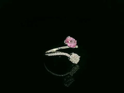 Pink sapphire diamond open wrap ring in 18K white gold with oval pink sapphire and diamond cluster
