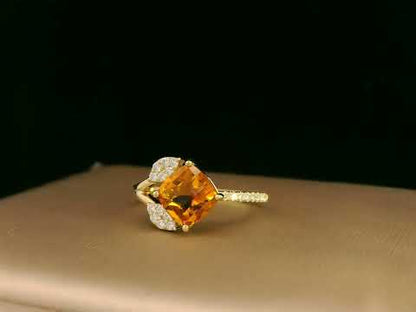 18K yellow gold ring featuring a 1.33ct cushion citrine with diamond leaf design, nature-inspired luxury style.