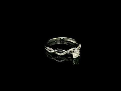 18K White Gold Diamond Engagement Ring with a 0.31 Carat Round Brilliant Diamond and 0.11 Carat Pavé Diamond Twisted Band.