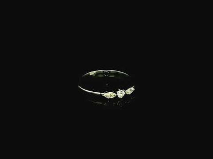 18K white gold three stone diamond ring featuring two marquise-cut diamonds and one round brilliant diamond with a total diamond weight of 0.22 carats.