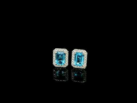Blue Topaz diamond halo stud earrings in 18K white gold featuring 2.36 carats of natural emerald-cut Blue Topaz and 0.32 carat natural diamonds.