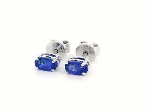 18K gold oval Tanzanite earrings featuring 0.62 carats of vibrant December birthstone in a dainty minimalist design – perfect for stacking and everyday wear.