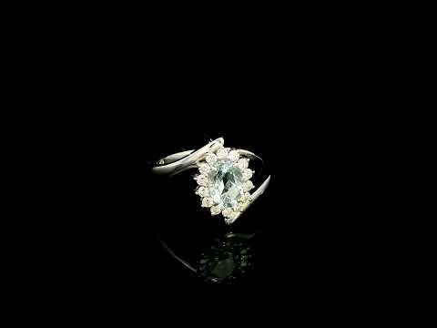 Oval aquamarine diamond halo ring with sweeping 18K white gold band