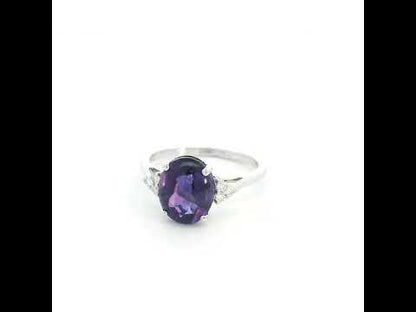 Natural oval cabochon amethyst ring in 18K white gold featuring a 2.92 carat purple amethyst and 0.08 carat natural diamond accents.